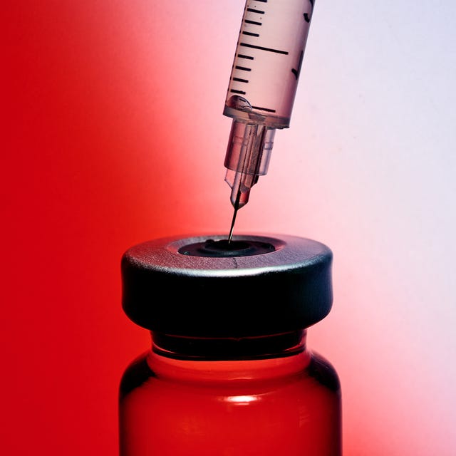 Syringe poised over a vial, ready for filling, against a gradient red and white background.