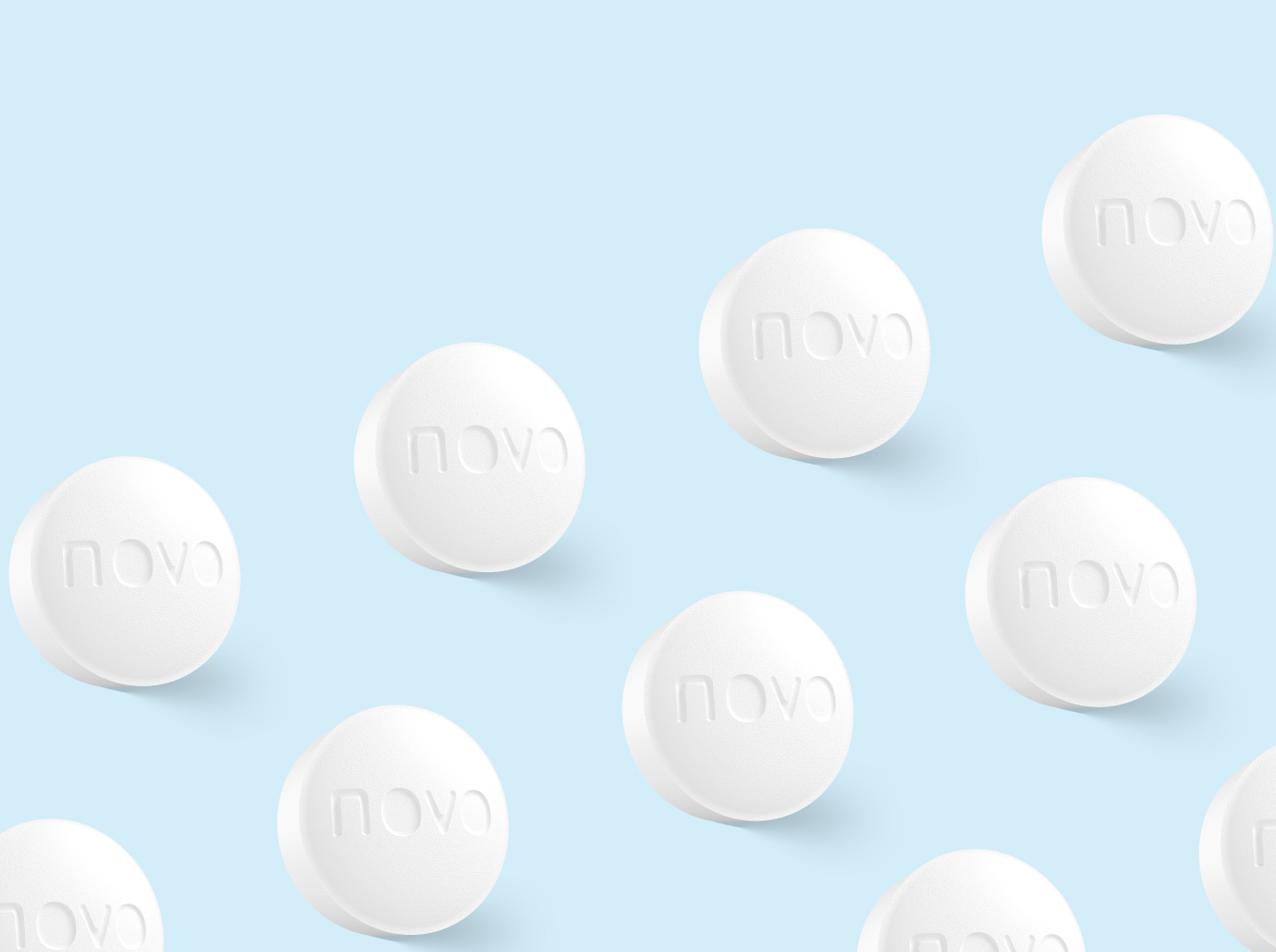 Multiple round white pills with novo text